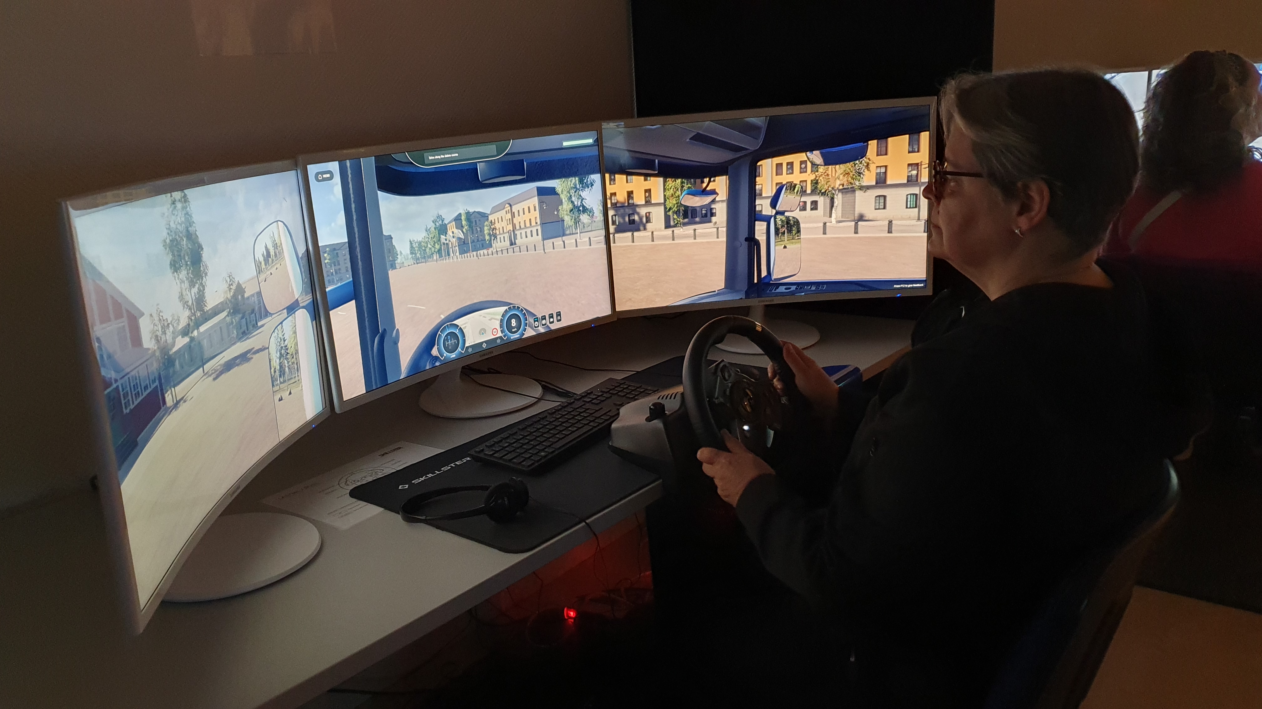 A woman driving a truck simulator