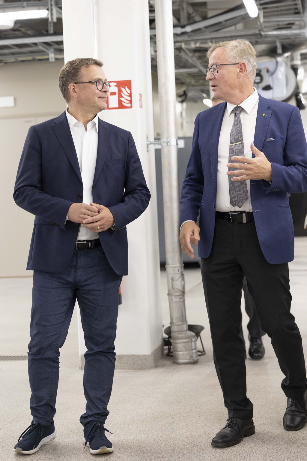 Kaksi pukumiestä kävelee.