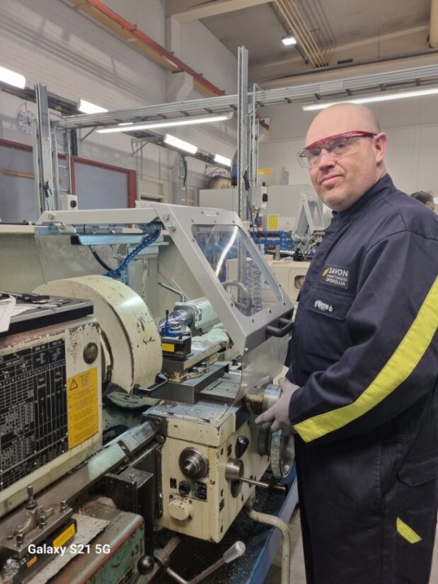 Opiskelija koneiden ääressä.