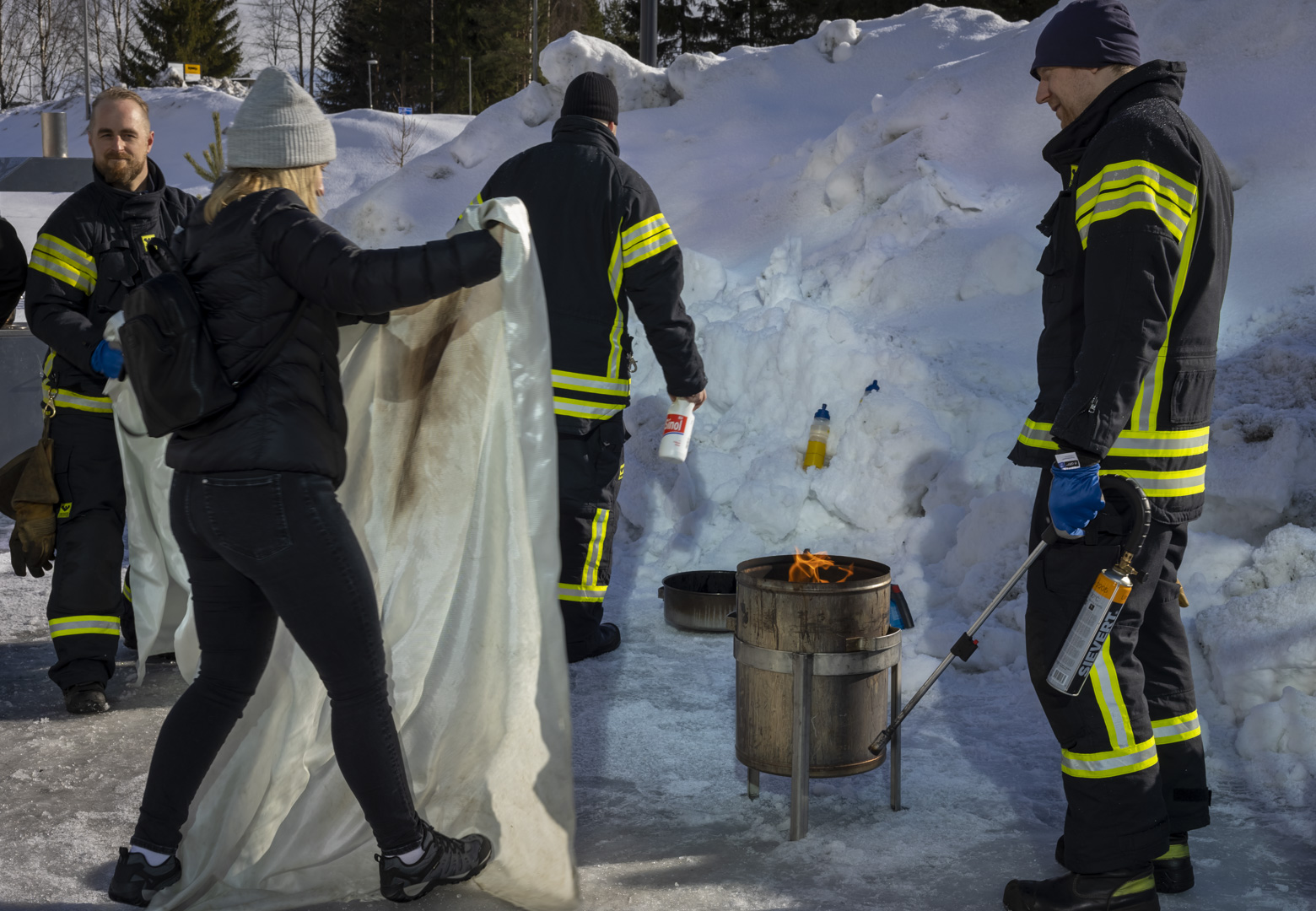 Opiskelija sammutuspeitteen kanssa.