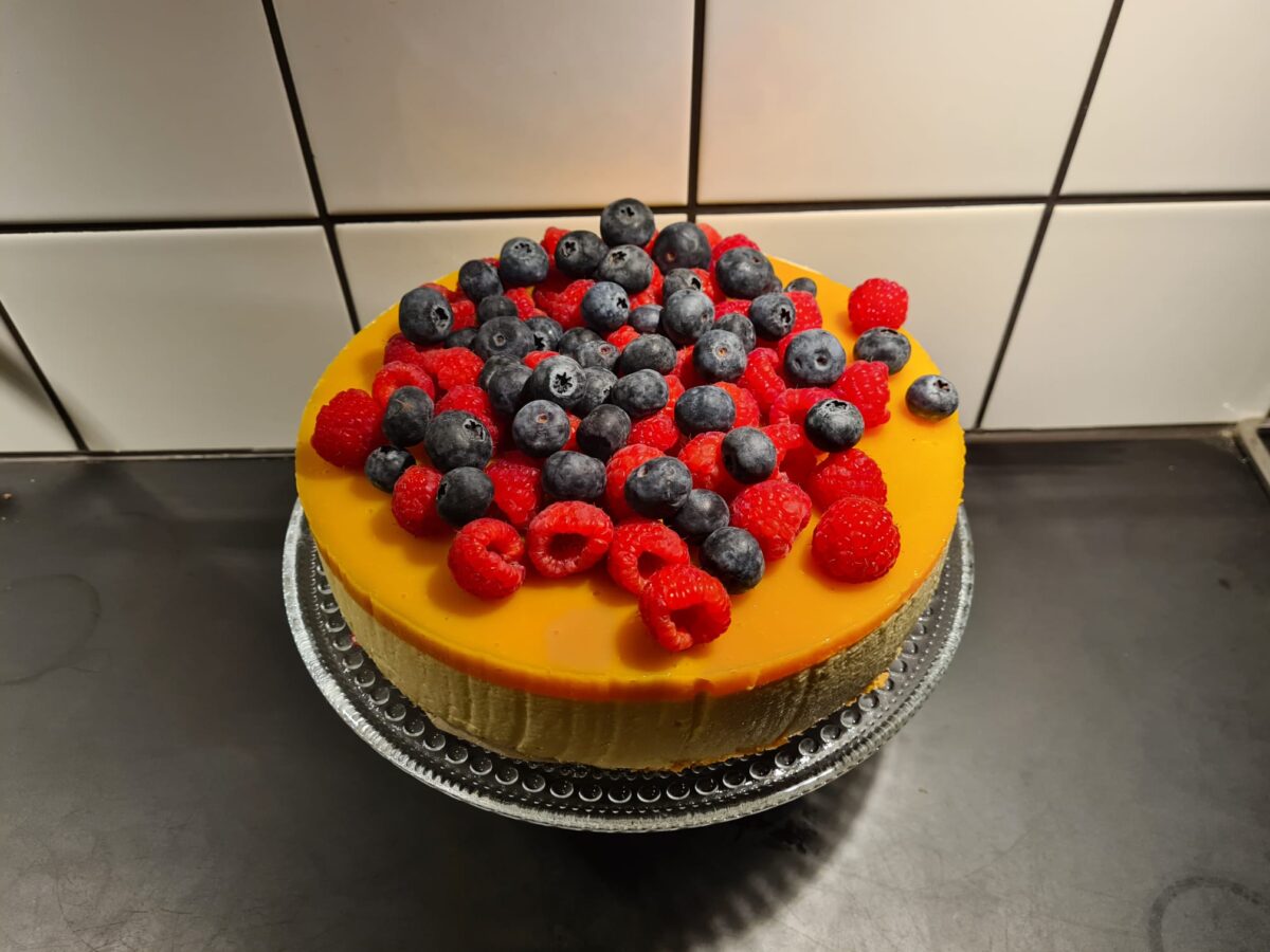 Kakku, jonka päällä on kesäisiä marjoja.